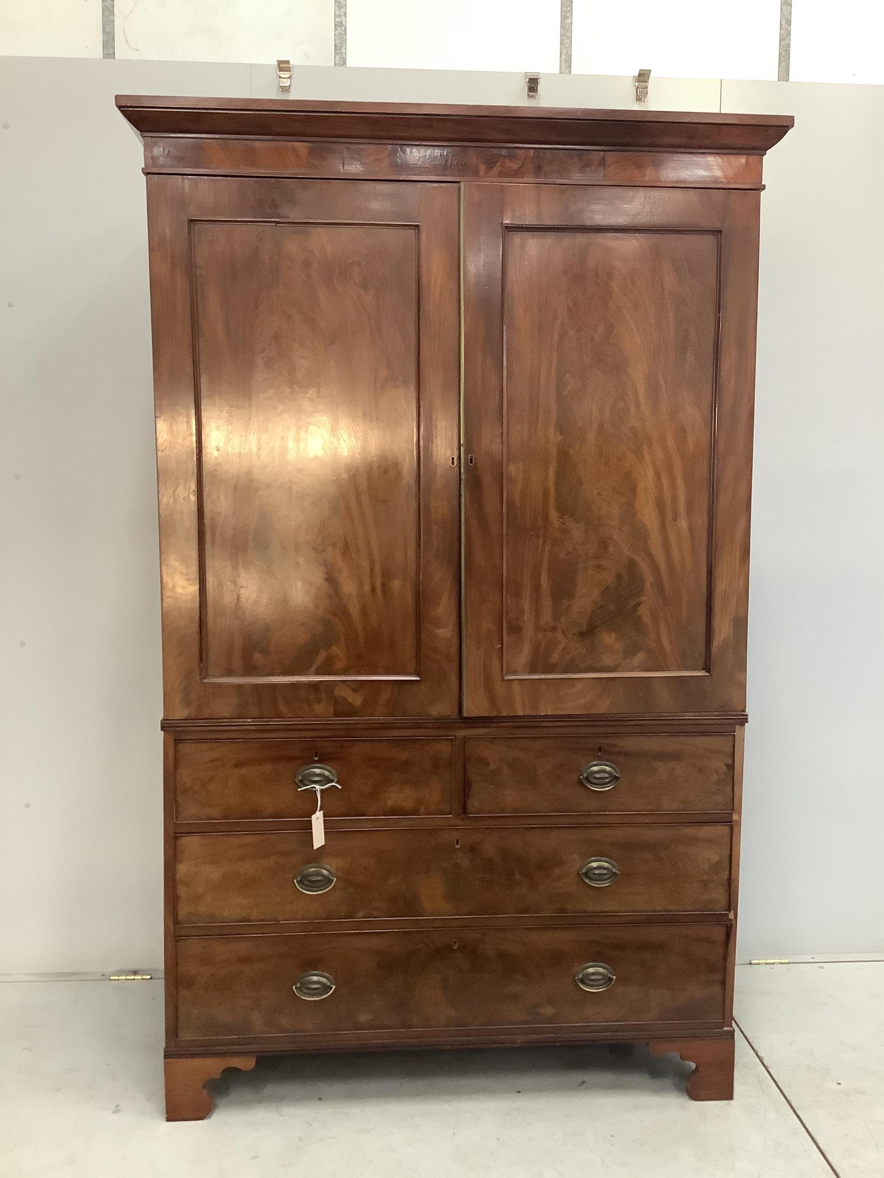 A George III mahogany linen press converted to a hanging wardrobe, width 130cm, depth 58cm, height 206cm. Condition - fair